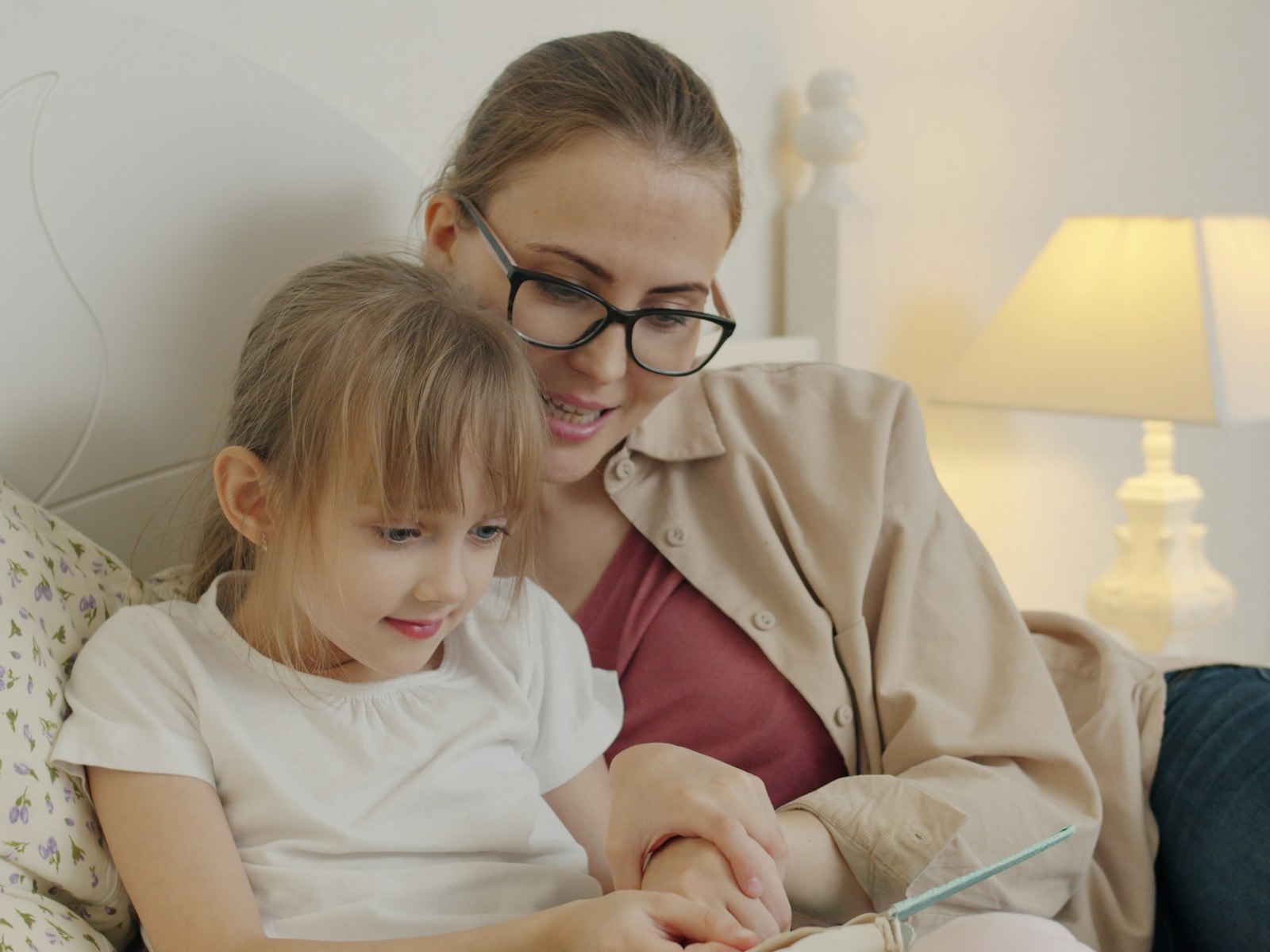 A parent and child looking at a tablet together at home