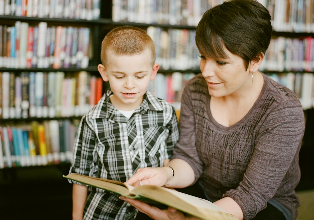 An adult reading with a young child